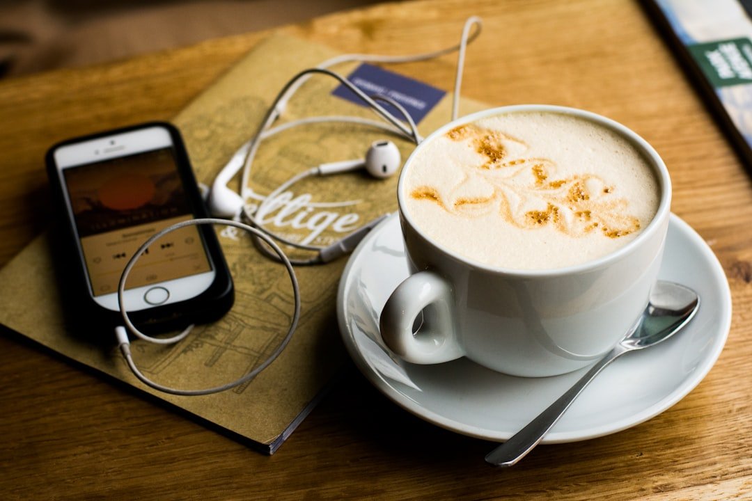 A quiet hot drink set beside headphones for a lower-caffeine evening routine.