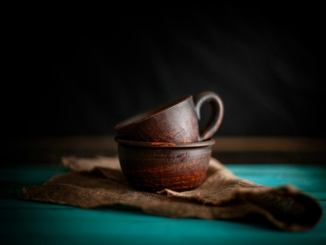 Two wooden cups stacked on a cloth