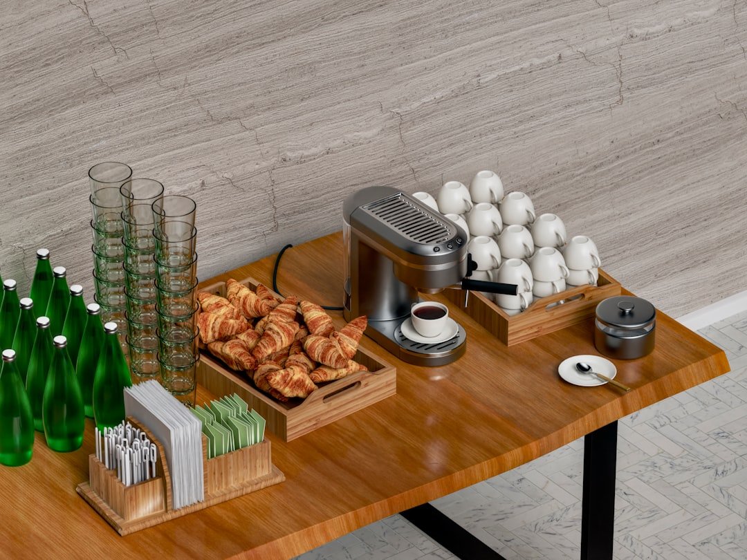 Coffee machine, cups, glasses, and breakfast pastries arranged on a home drink station.